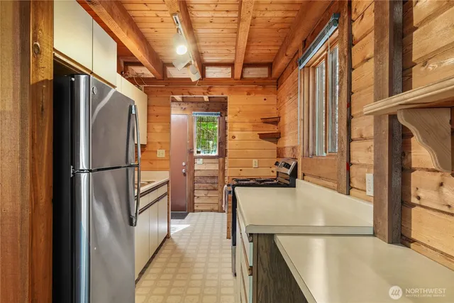 a view of a kitchen with a refrigerator and a stove
