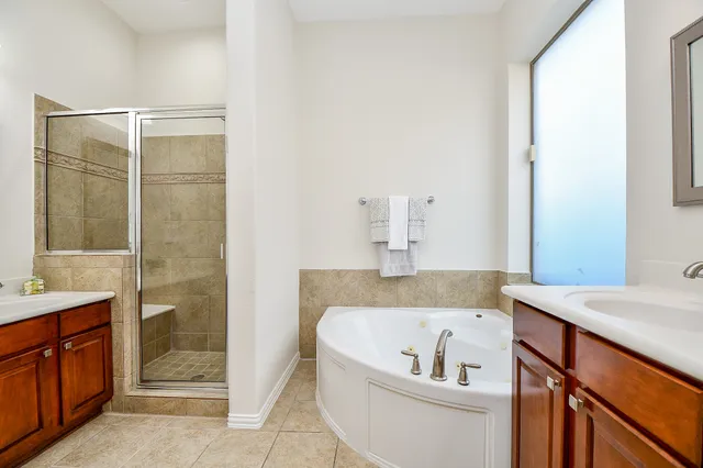 a view of a house with a small yard and wooden fence