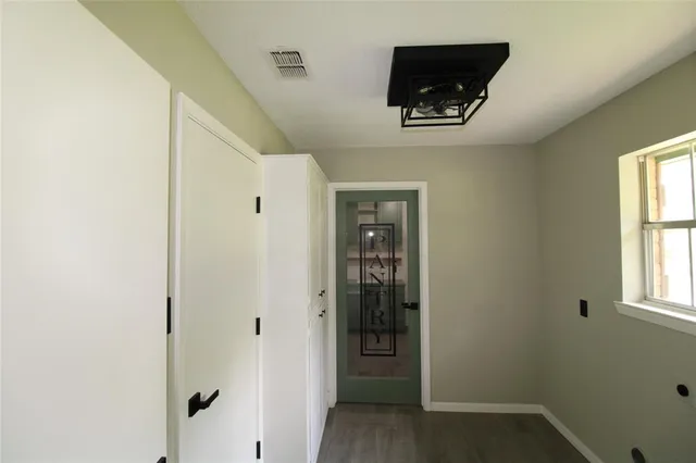 a hallway with closet and a window