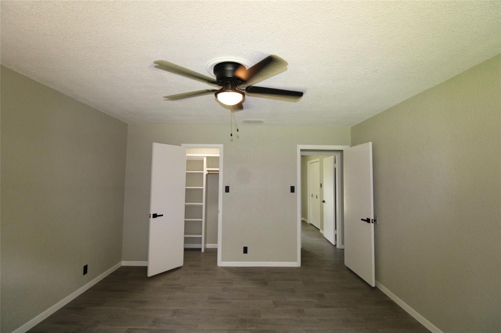 818 East Clinton Avenue Athens, TX 75751 - Photo 17 of 24 an empty room with closet and a chandelier fan