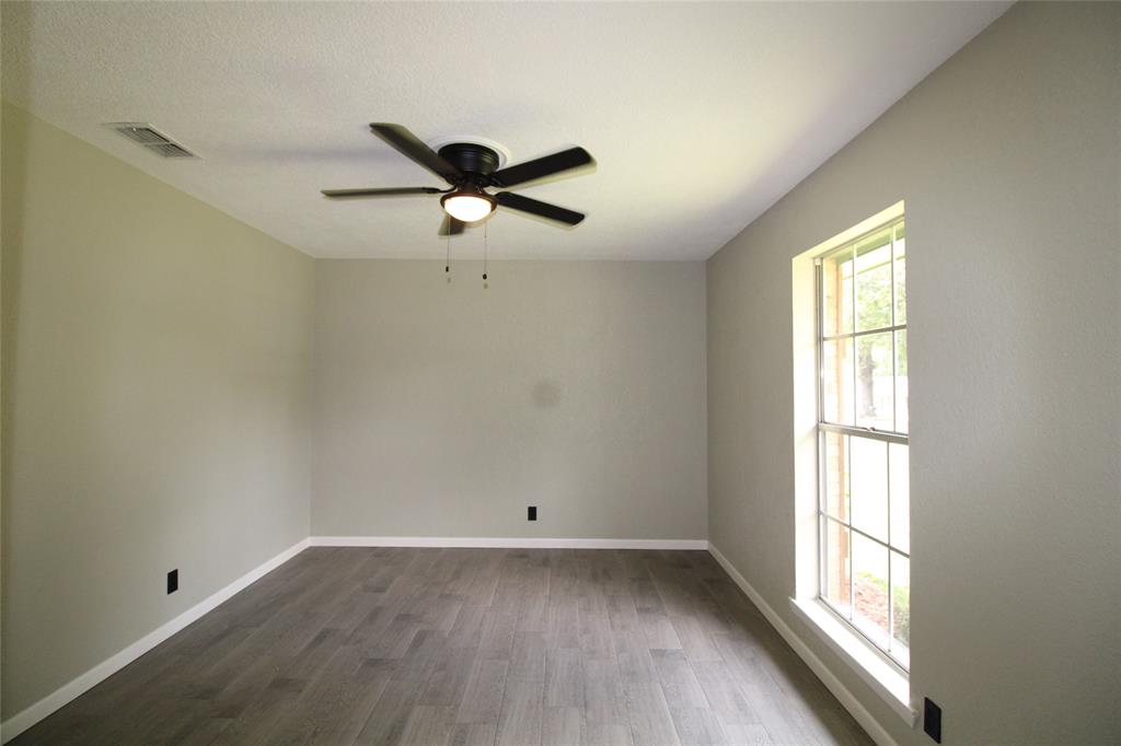 818 East Clinton Avenue Athens, TX 75751 - Photo 20 of 24 an empty room with a window and a fan