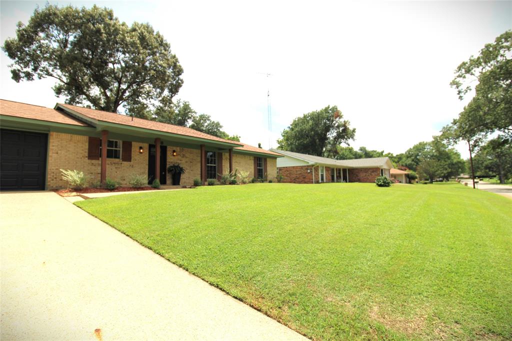 818 East Clinton Avenue Athens, TX 75751 - Photo 2 of 24 a front view of house with yard and outdoor seating