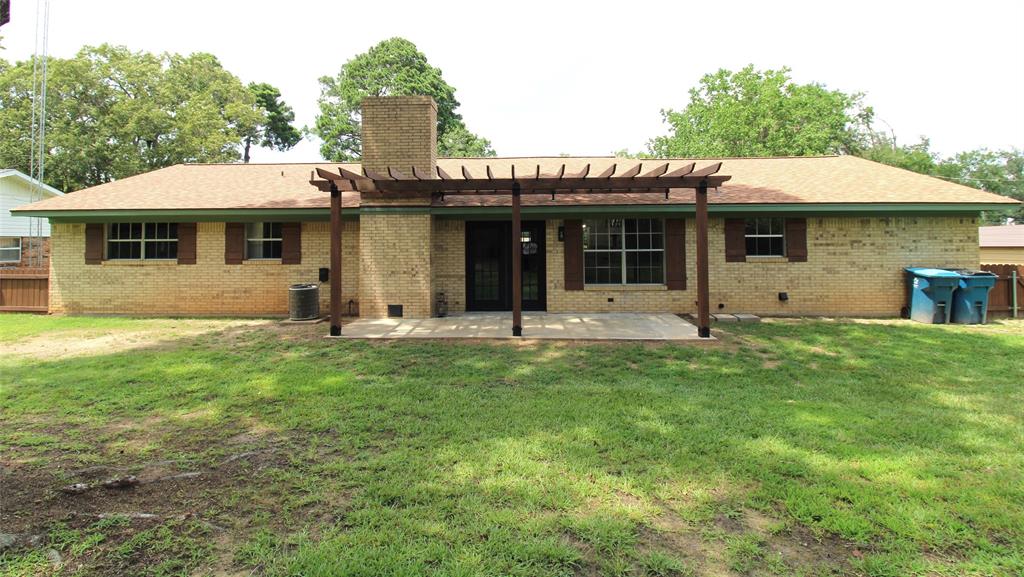 818 East Clinton Avenue Athens, TX 75751 - Photo 22 of 24 a front view of a house with a garden
