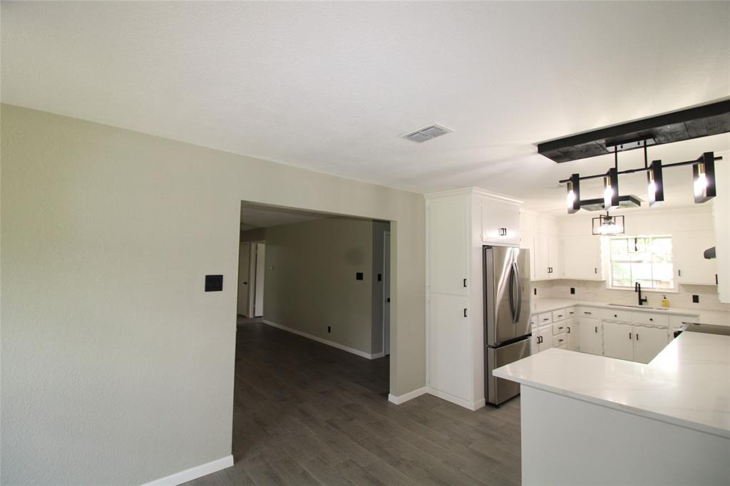 818 East Clinton Avenue Athens, TX 75751 - Photo 6 of 24 a view of a kitchen with a sink and wooden floor