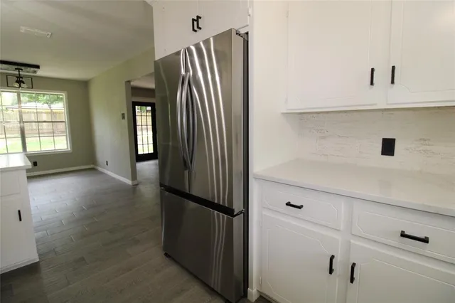a view of kitchen with furniture and refrigerator