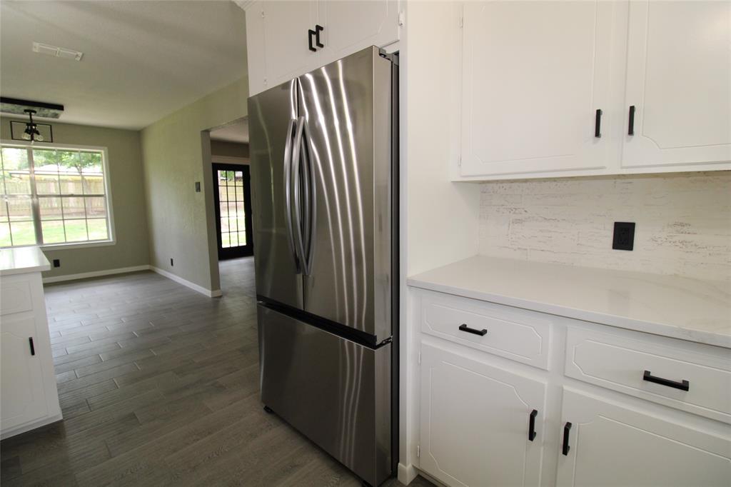 818 East Clinton Avenue Athens, TX 75751 - Photo 7 of 24 a view of kitchen with furniture and refrigerator