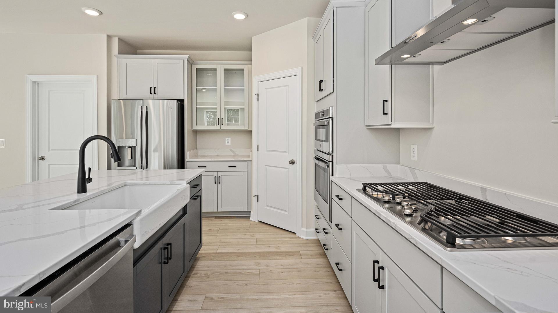 13423 Reconnaissance Ridge Road Fredericksburg, VA 22407 - Photo 9 of 41 a kitchen with stainless steel appliances a sink stove and refrigerator