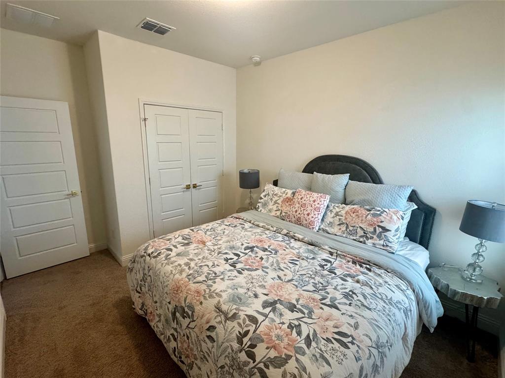 7024 Tree Stand Point Little Elm, TX 76227 - Photo 19 of 30 a bedroom with a bed and closet