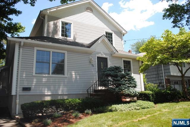 75 Columbus Drive Tenafly, NJ 07670 - Photo 1 of 26 a front view of a house with garden