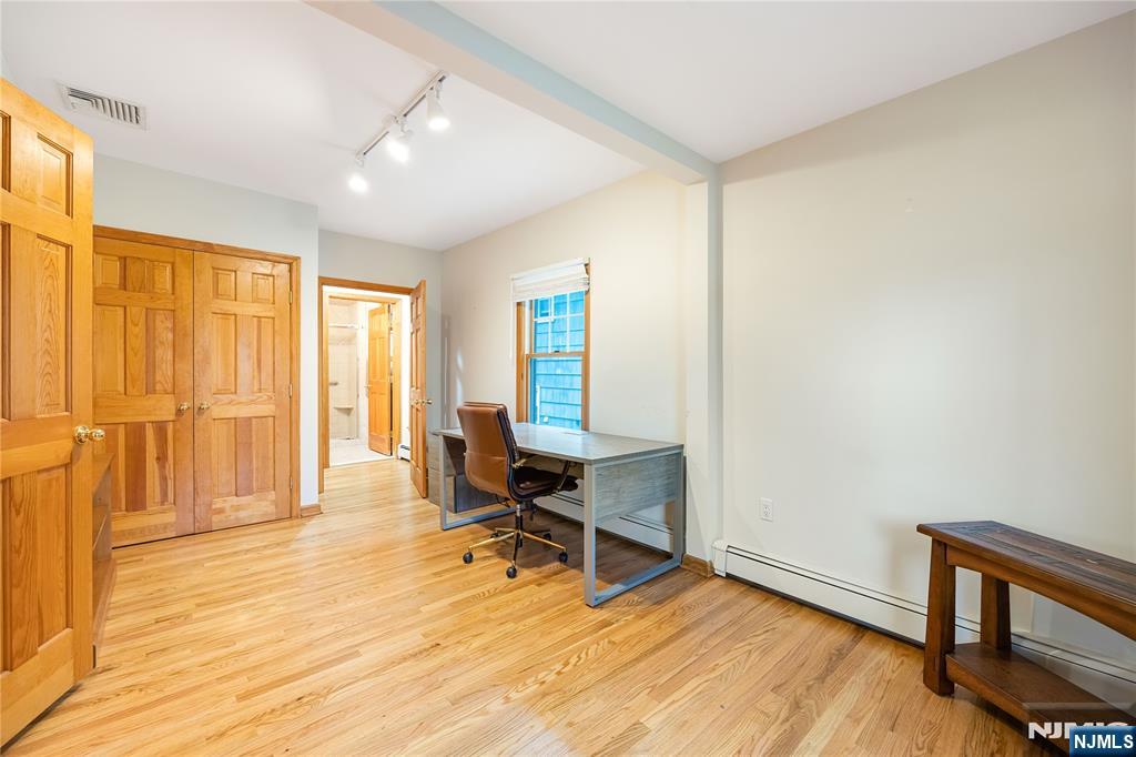 75 Columbus Drive Tenafly, NJ 07670 - Photo 11 of 26 a view of a room with wooden floor and furniture