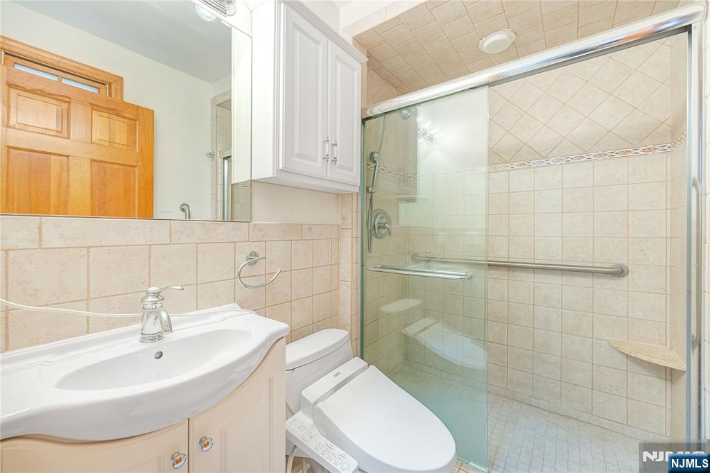 75 Columbus Drive Tenafly, NJ 07670 - Photo 13 of 26 a bathroom with a sink toilet and shower