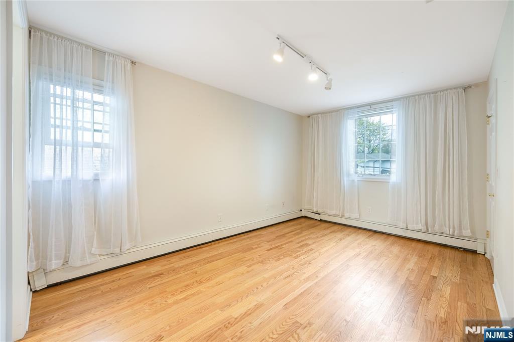 75 Columbus Drive Tenafly, NJ 07670 - Photo 15 of 26 a view of an empty room with wooden floor and a window