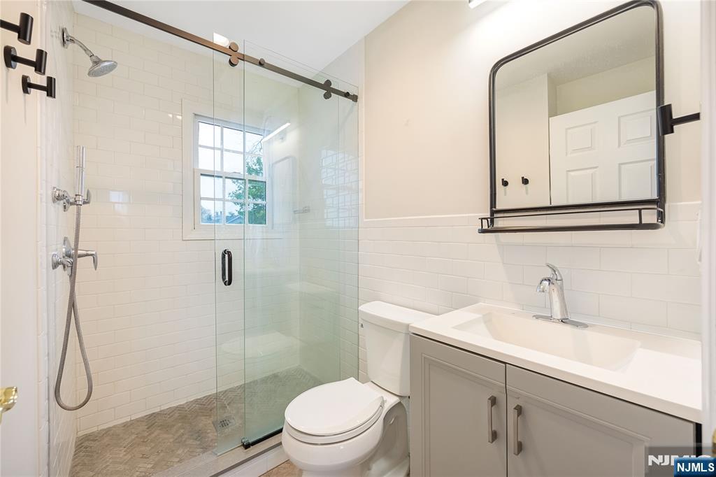 75 Columbus Drive Tenafly, NJ 07670 - Photo 17 of 26 a bathroom with a sink a toilet and shower