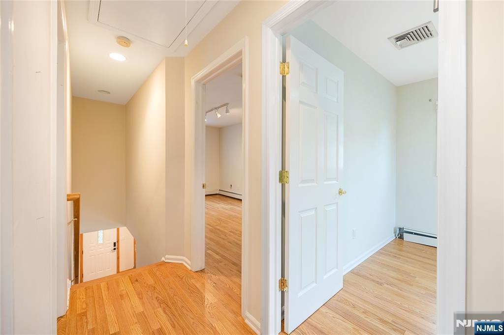 75 Columbus Drive Tenafly, NJ 07670 - Photo 18 of 26 a bedroom with a bed and wooden floor