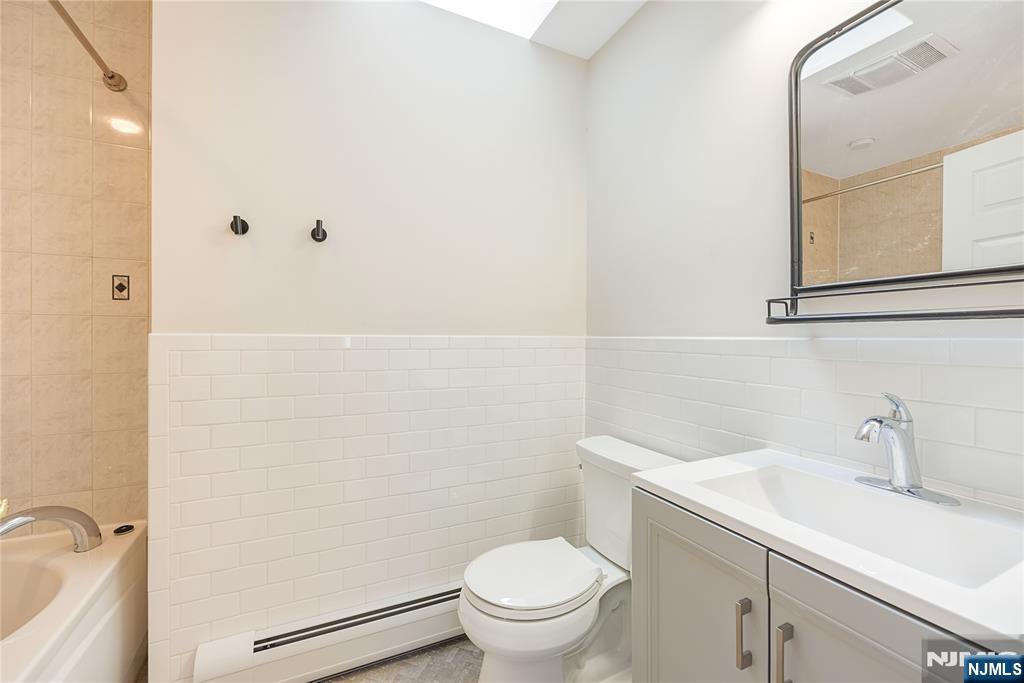 75 Columbus Drive Tenafly, NJ 07670 - Photo 20 of 26 a bathroom with a sink a toilet and a mirror