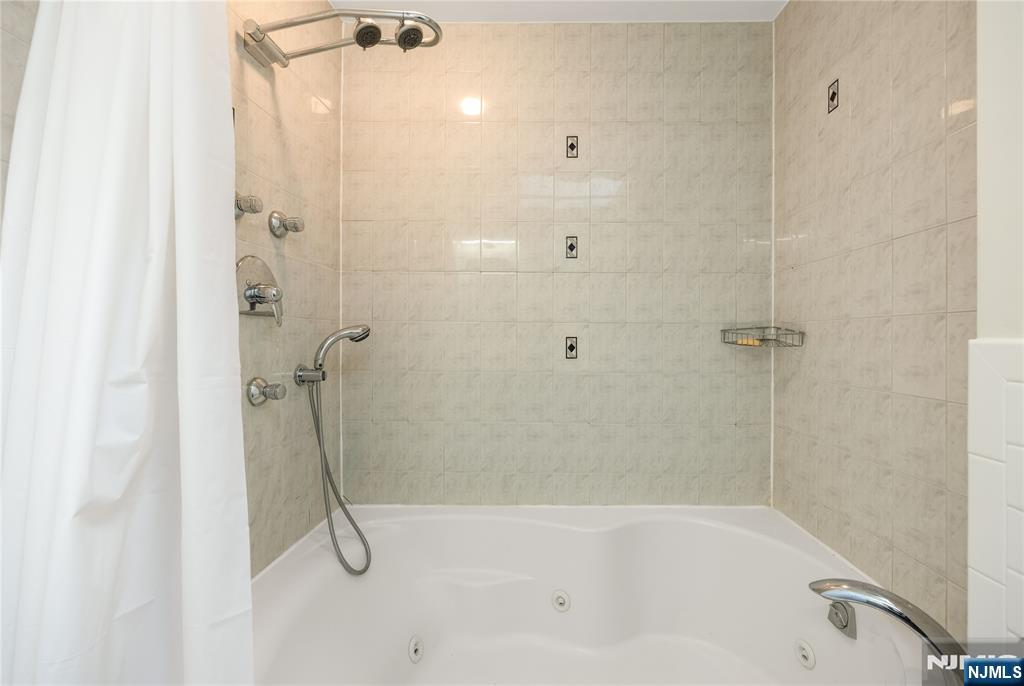 75 Columbus Drive Tenafly, NJ 07670 - Photo 21 of 26 a bathroom with a bath tub with a shower