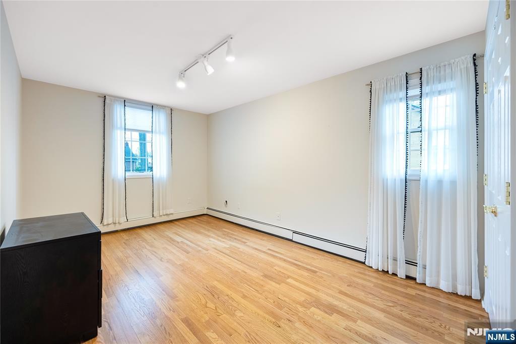 75 Columbus Drive Tenafly, NJ 07670 - Photo 10 of 26 a view of an empty room with wooden floor