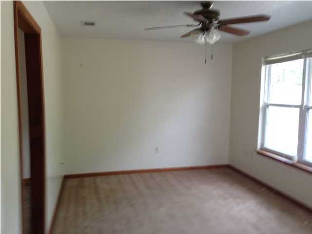 6018 Sand Hill Road Crestview, FL 32539 - Photo 11 of 11 an empty room with a window and a fan