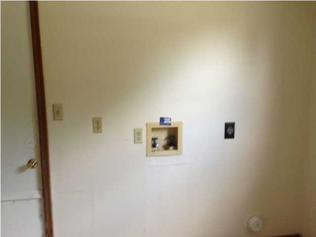 6018 Sand Hill Road Crestview, FL 32539 - Photo 5 of 11 a wall with a refrigerator in it