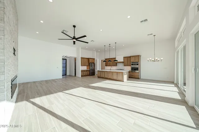 a view of a kitchen with sink and stainless steel appliances