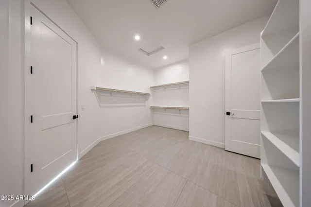 a spacious bathroom with a tub shower and mirror