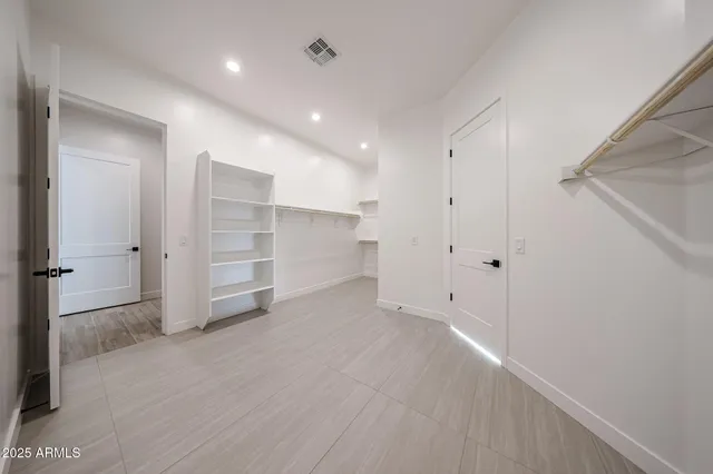 a bathroom with a bathtub and a chandelier