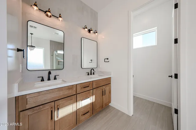 a spacious bathroom with a double vanity sink mirror and