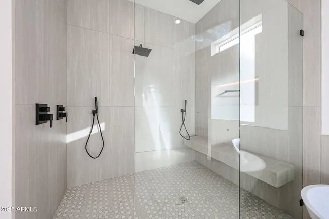 a view of an empty room with wooden floor and a ceiling fan