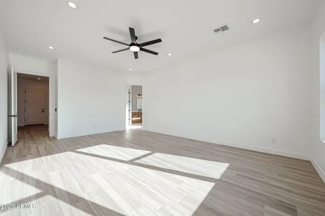 a bathroom with a toilet sink vanity and mirror