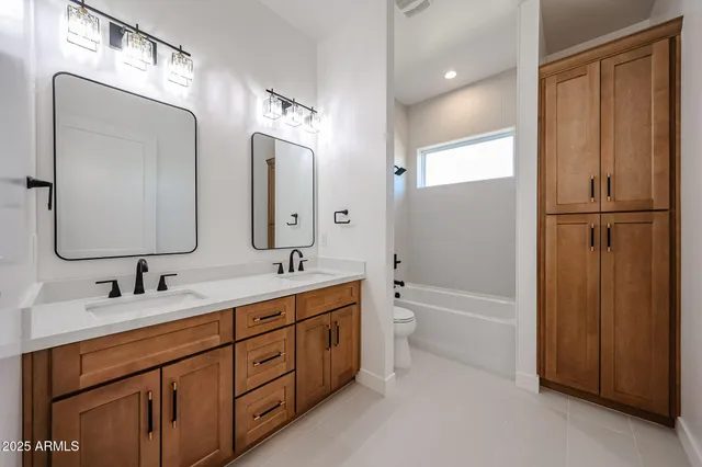 an empty room with wooden floor ceiling fan and windows