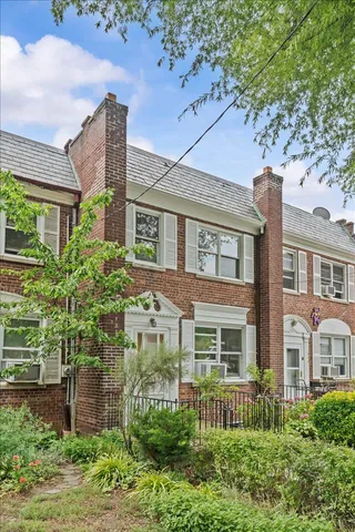 a view of a house with a small yard and plants