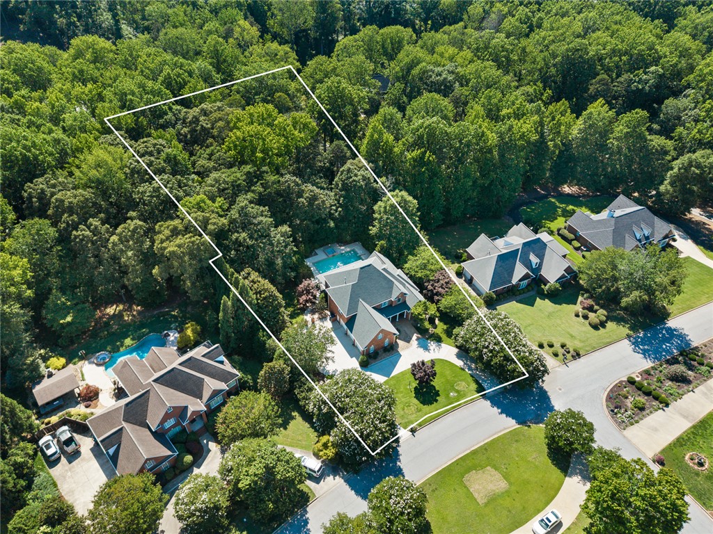 200 Graylyn Drive Anderson, SC 29621 - Photo 48 of 48 An aerial perspective reveals a private residential oasis surrounded by lush greenery, featuring a sparkling backyard pool.
