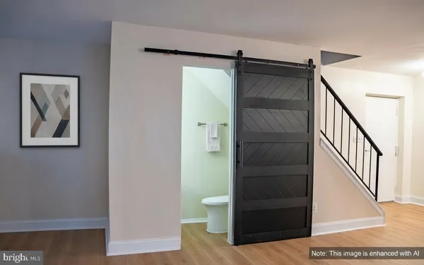 a view of a hallway with wooden floor and staircase