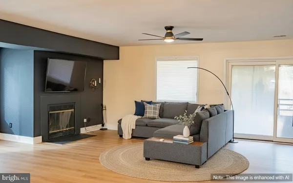 a living room with fireplace furniture and a flat screen tv