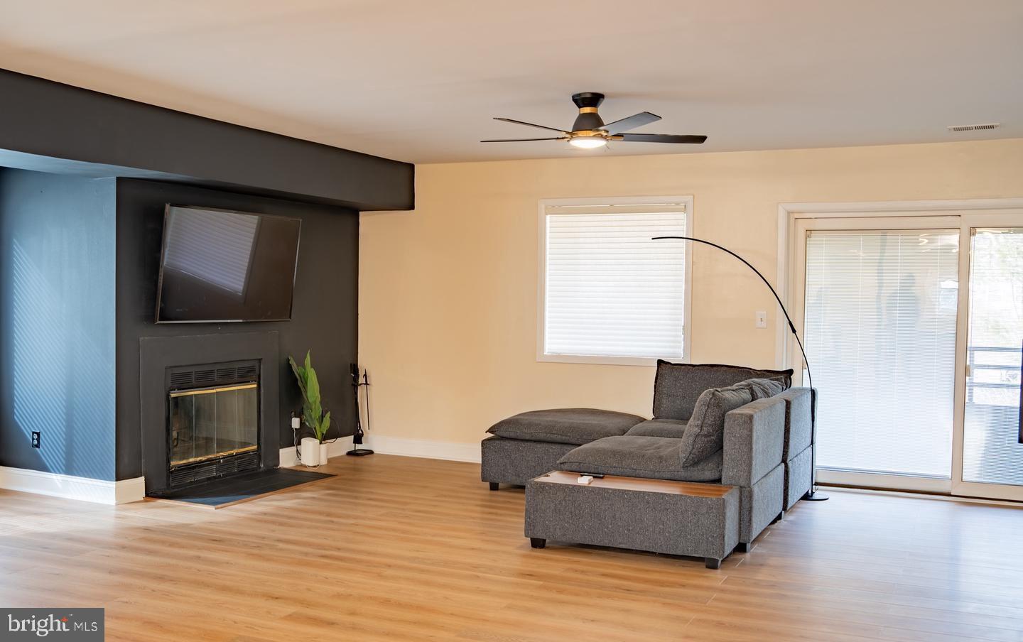 6907 Jones View Drive, Unit 3A Baltimore, MD 21209 - Photo 14 of 19 a living room with furniture and a fireplace