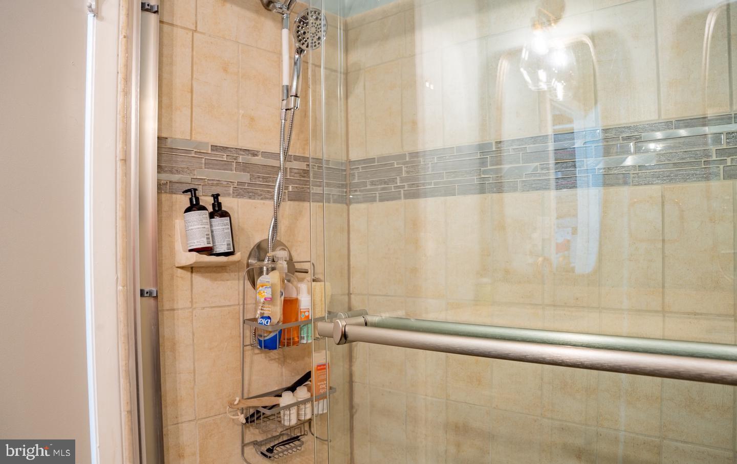 6907 Jones View Drive, Unit 3A Baltimore, MD 21209 - Photo 16 of 19 a view of a bathroom with a shower and a window