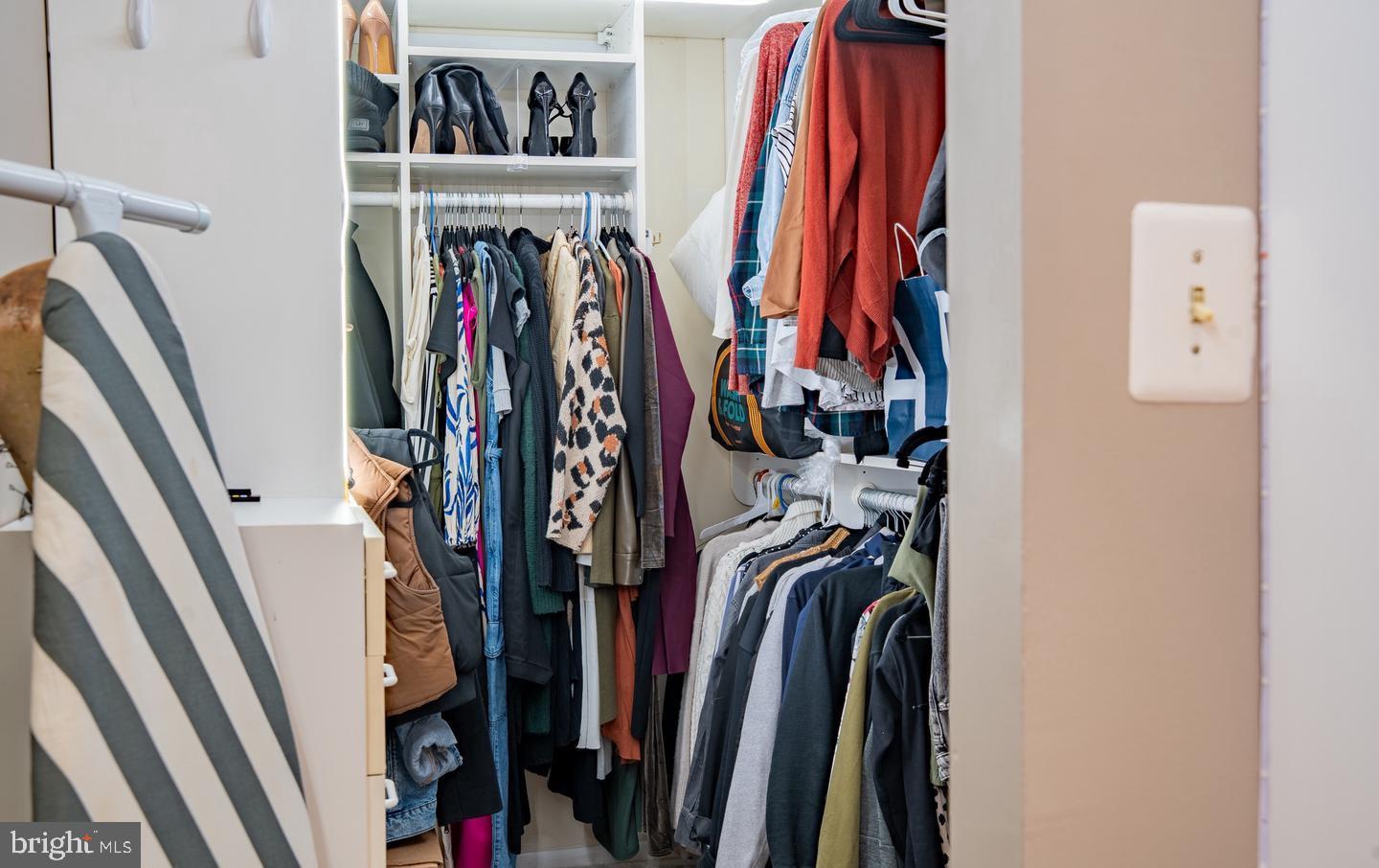 6907 Jones View Drive, Unit 3A Baltimore, MD 21209 - Photo 18 of 19 a view of walk in closet with clothes