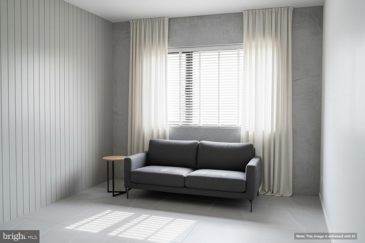 6907 Jones View Drive, Unit 3A Baltimore, MD 21209 - Photo 4 of 12 a living room with furniture and a window