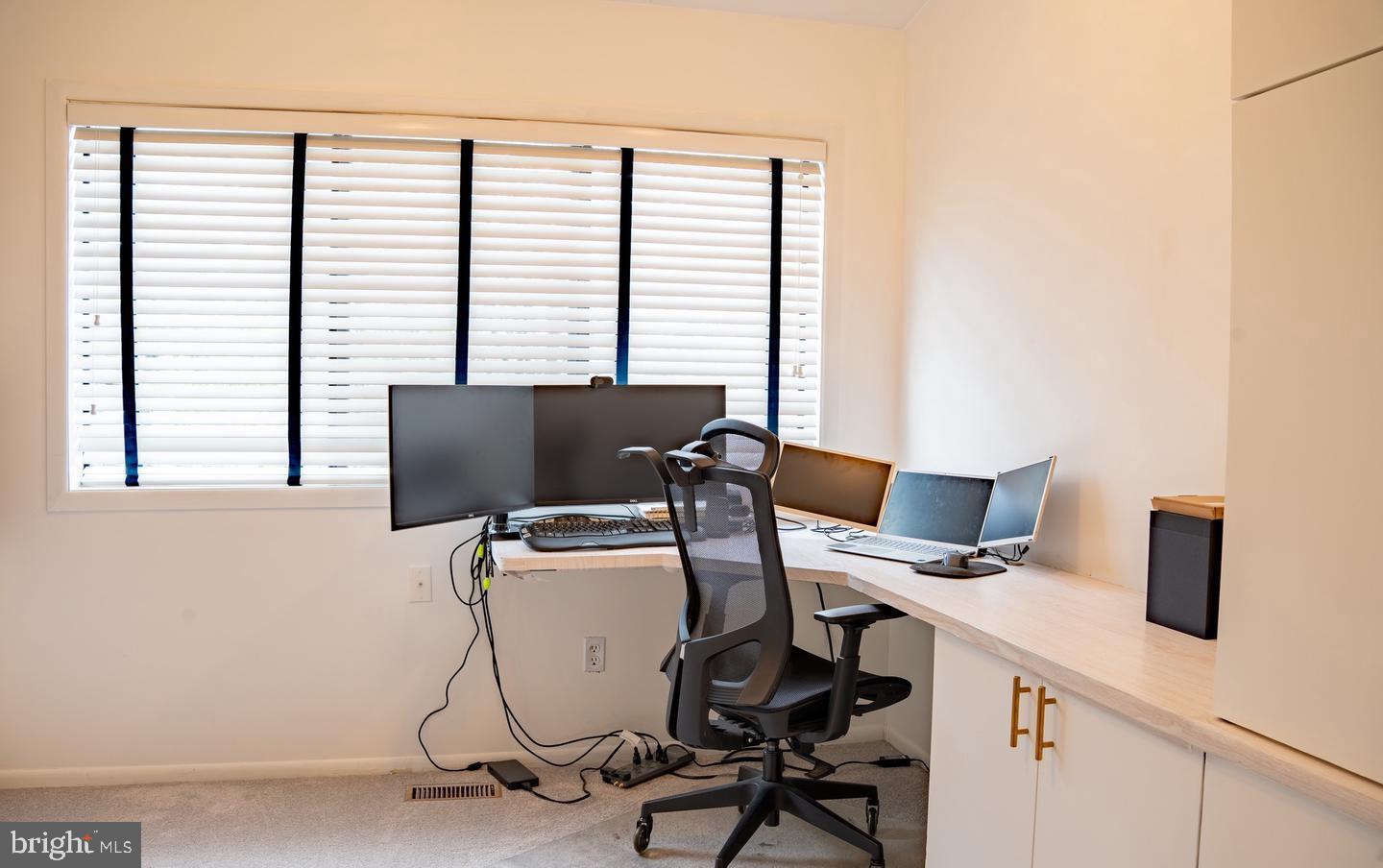 6907 Jones View Drive, Unit 3A Baltimore, MD 21209 - Photo 4 of 19 a work place that has a desk chair and white wooden floor