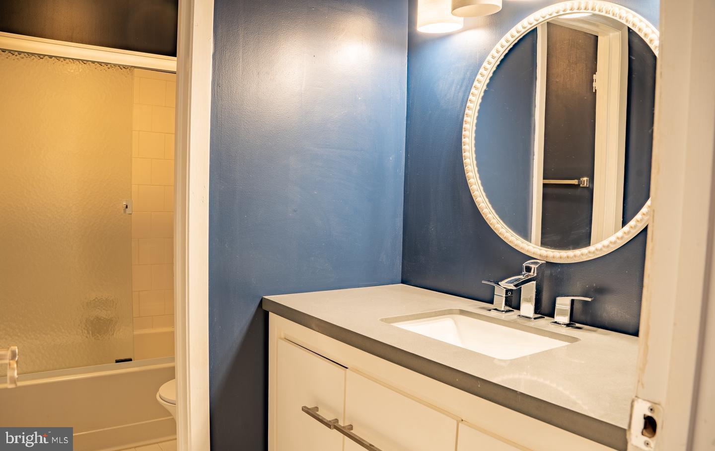 6907 Jones View Drive, Unit 3A Baltimore, MD 21209 - Photo 7 of 19 a bathroom with a sink and a mirror