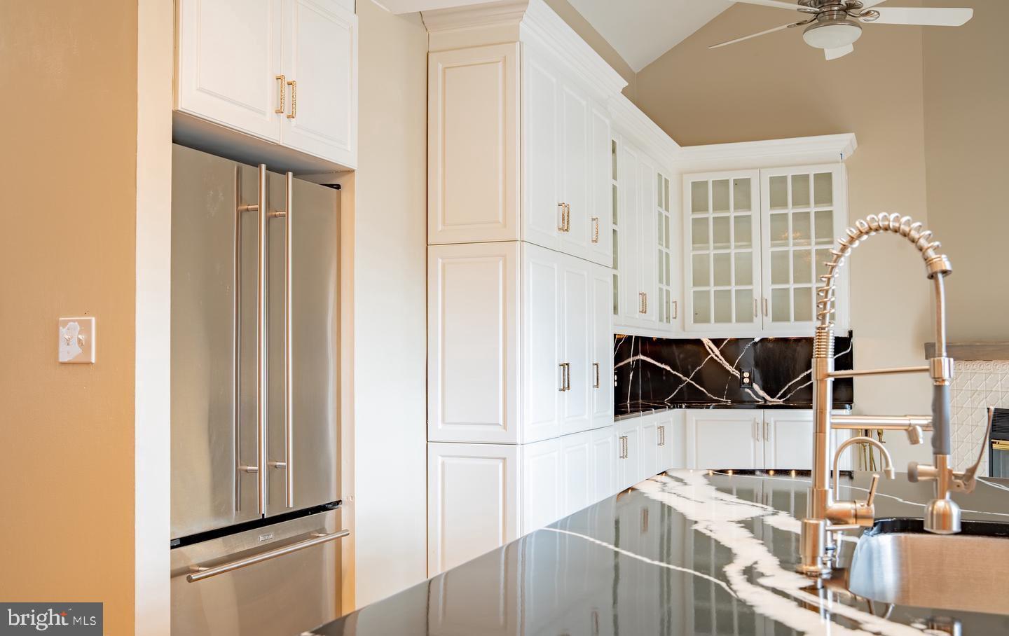 6907 Jones View Drive, Unit 3A Baltimore, MD 21209 - Photo 10 of 19 a kitchen with stainless steel appliances kitchen island a refrigerator sink and cabinets