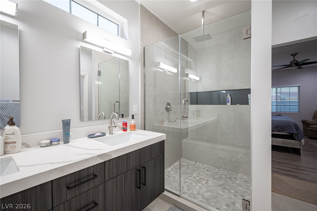 441 Belville Road Pahrump, NV 89048 - Photo 32 of 44 A well-appointed primary bathroom showcases a dual vanity with ample counter space and a sleek glass-enclosed shower.