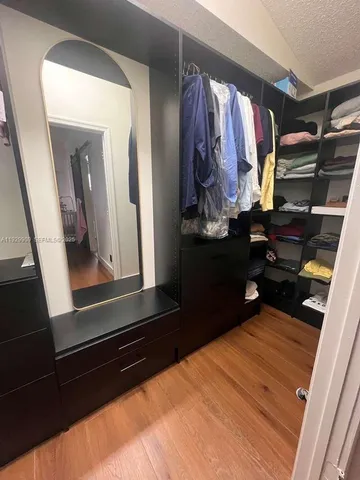 a bedroom with a bed and a mirror