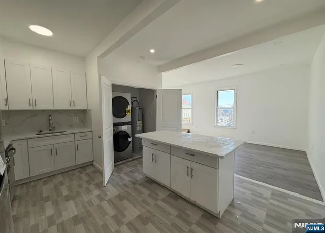 a kitchen with a sink stove and cabinets