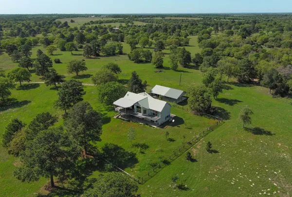 an aerial view of a house with a yard