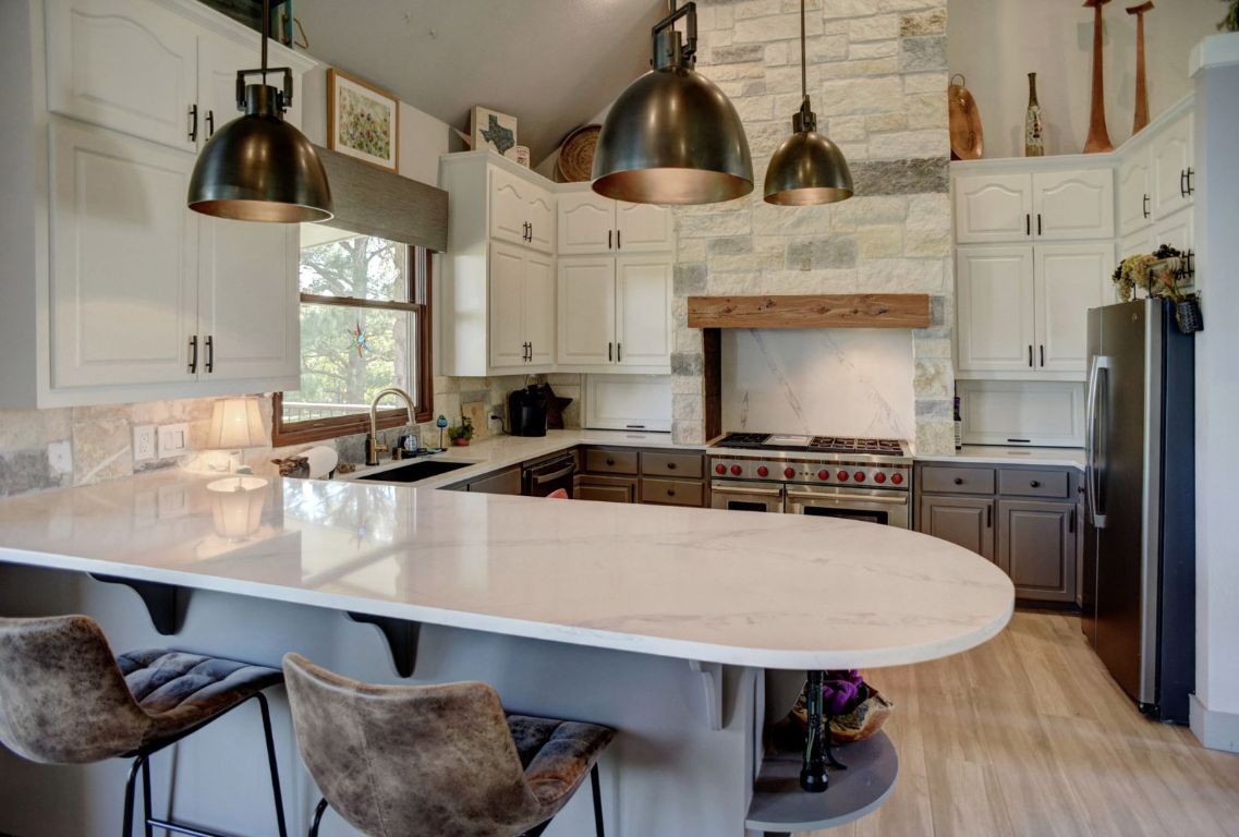 490 John Craft Road Red Rock, TX 78662 - Photo 14 of 40 a kitchen with stainless steel appliances a sink a stove and a wooden floor