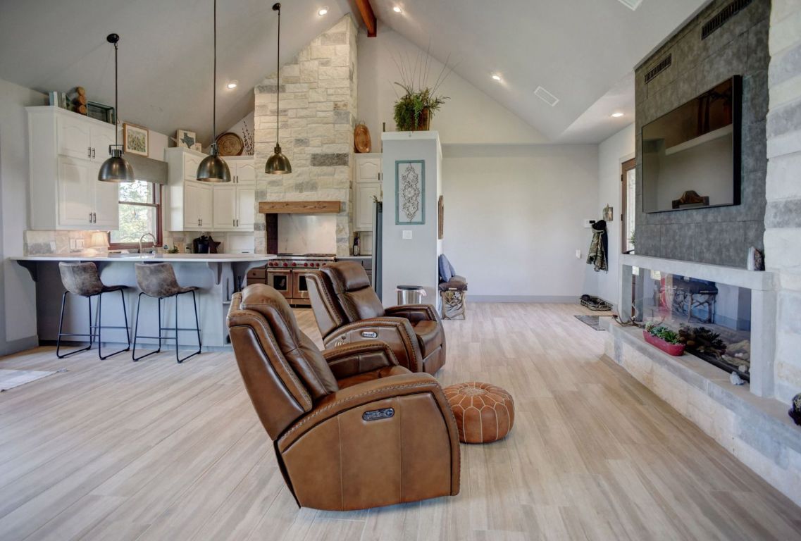 490 John Craft Road Red Rock, TX 78662 - Photo 18 of 40 a living room with furniture fireplace and a flat screen tv