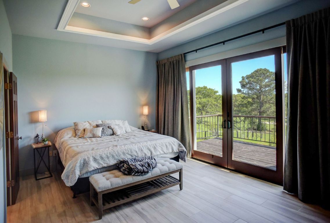 490 John Craft Road Red Rock, TX 78662 - Photo 19 of 40 a bedroom with a bed and a large window