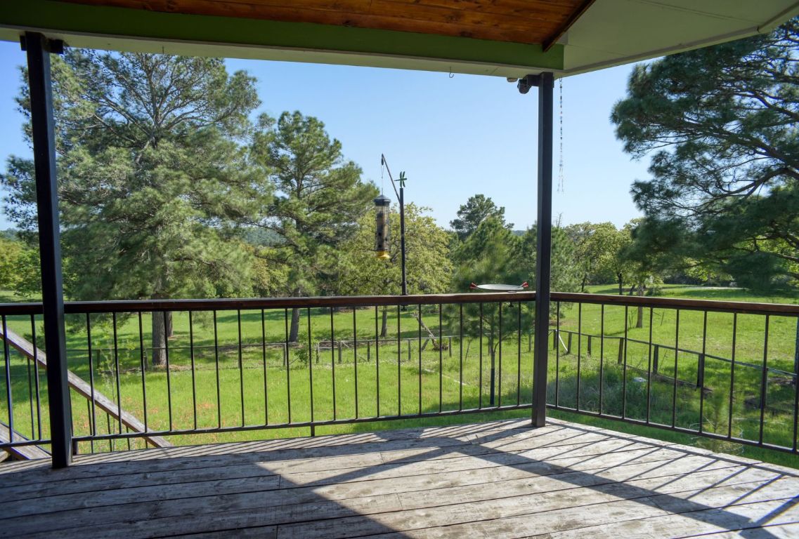490 John Craft Road Red Rock, TX 78662 - Photo 24 of 40 a view of a balcony with lake view and a floor to ceiling window