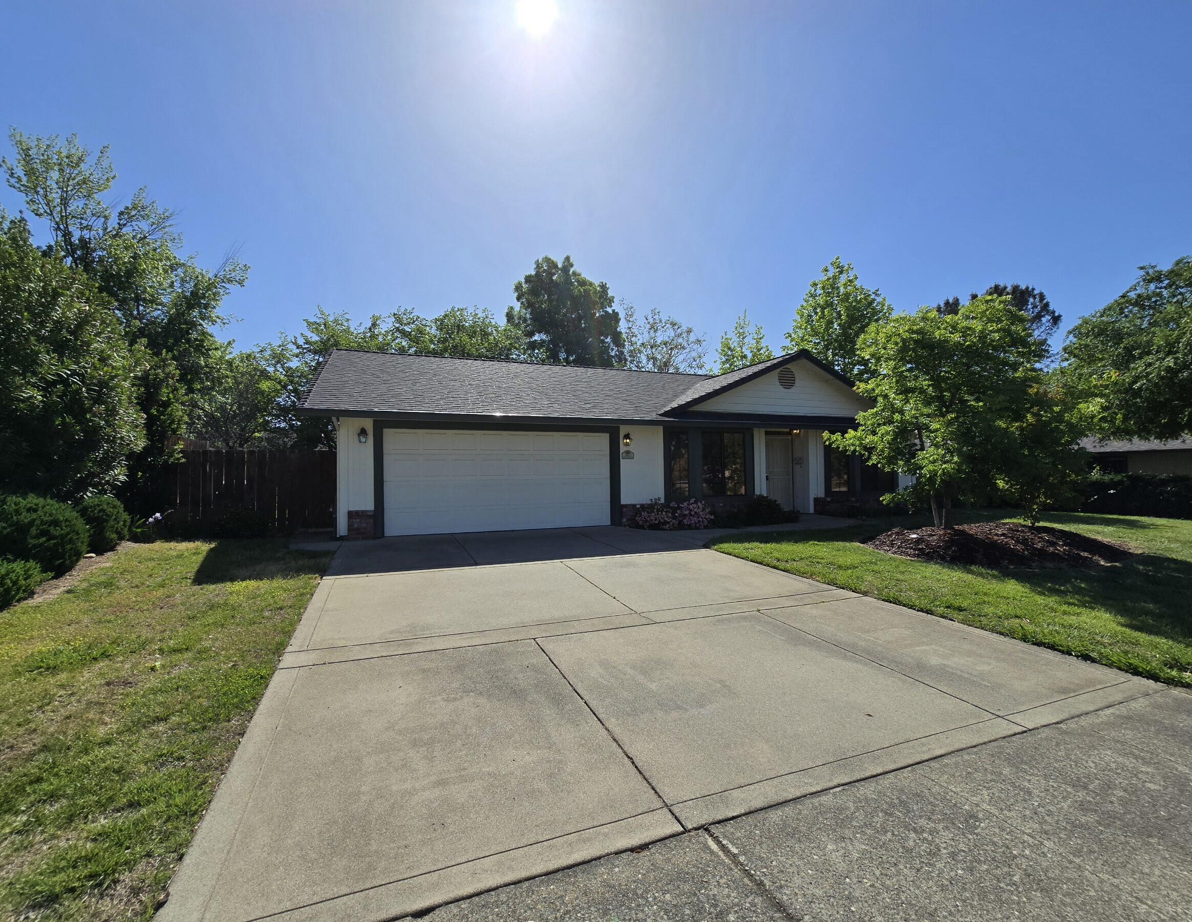 3671 Santa Rosa Way Redding, CA 96003 - Photo 1 of 26 a front view of a house with a yard and garage